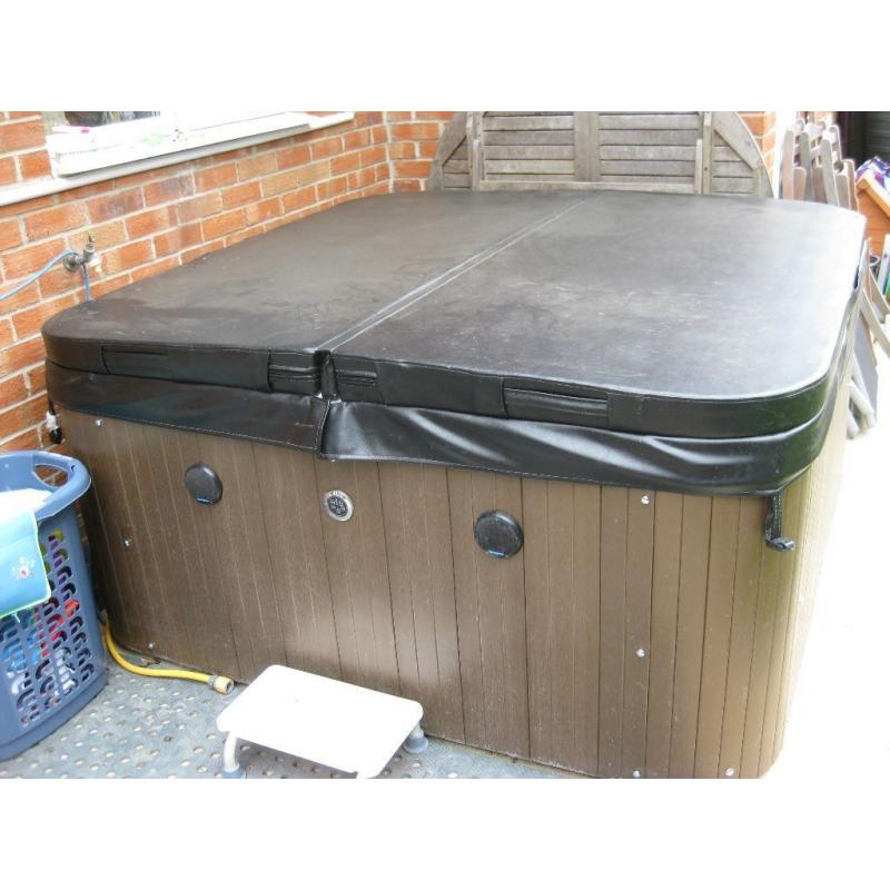 Crystal Cove 6-seat hot tub with lid and starter kit.