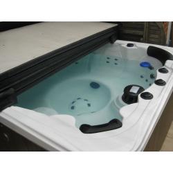 Crystal Cove 6-seat hot tub with lid and starter kit.