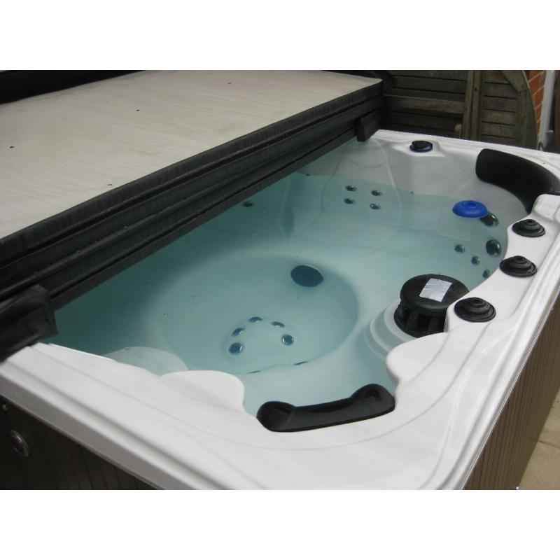 Crystal Cove 6-seat hot tub with lid and starter kit.