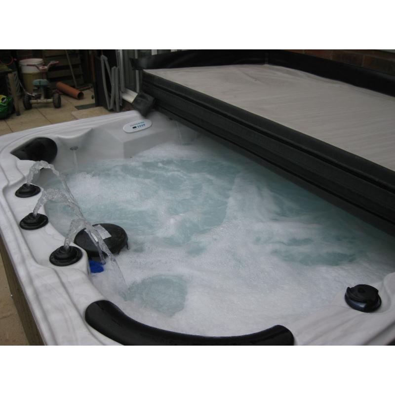 Crystal Cove 6-seat hot tub with lid and starter kit.