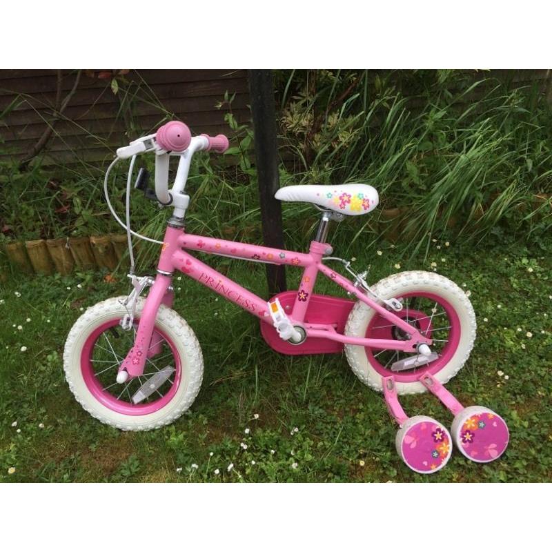 Pink girls bike with stabilisers