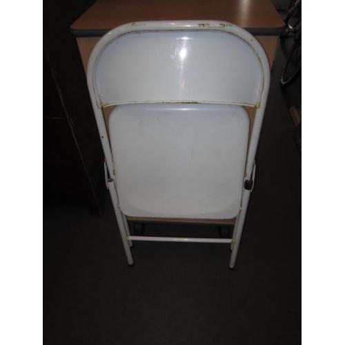 Folding chair . White colour . Made of metal .