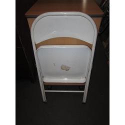 Folding chair . White colour . Made of metal .