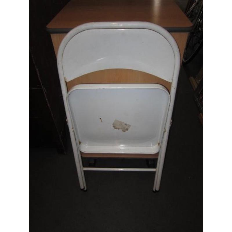 Folding chair . White colour . Made of metal .