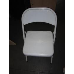 Folding chair . White colour . Made of metal .