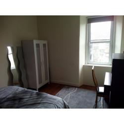 Spacious double bedroom in freshly renovated flat during festive period