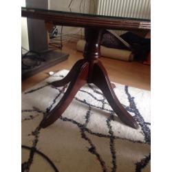 Glass topped wooden coffee table