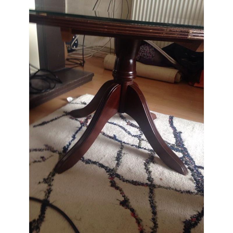 Glass topped wooden coffee table