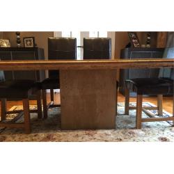 Stone dining table and six leather chairs