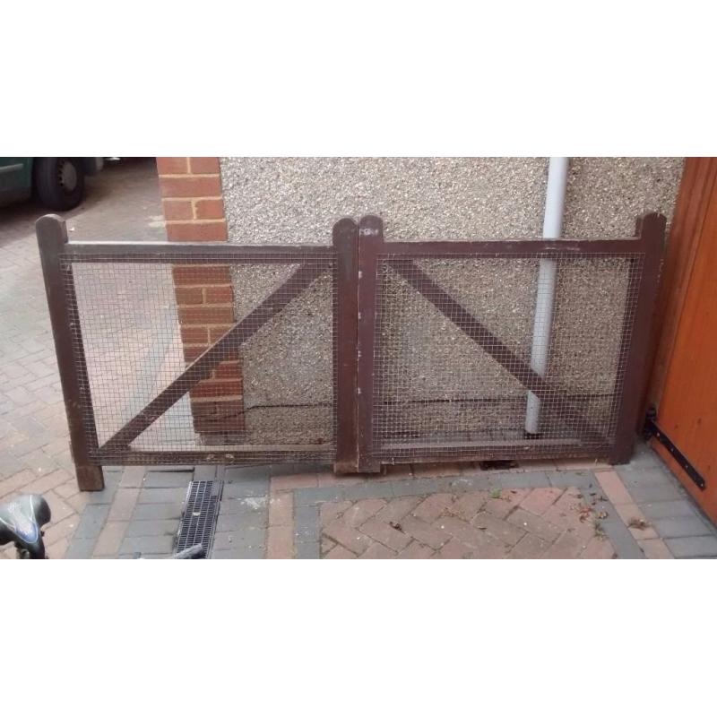 Double gates for driveway or garden. Wooden frame, mesh panels.