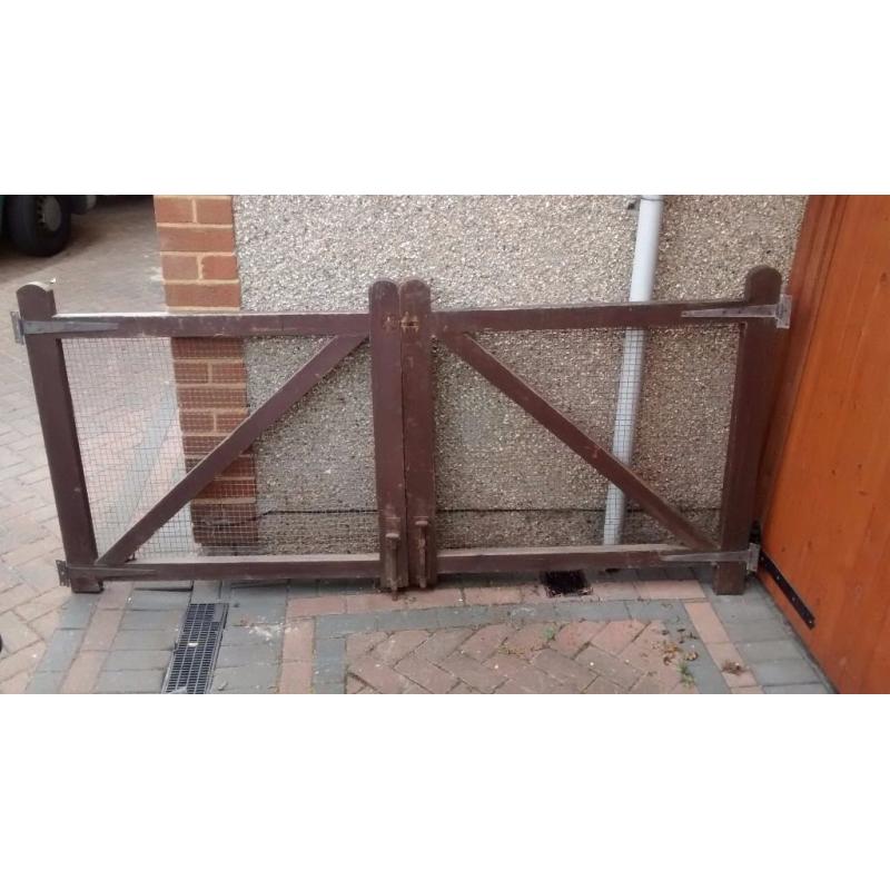 Double gates for driveway or garden. Wooden frame, mesh panels.