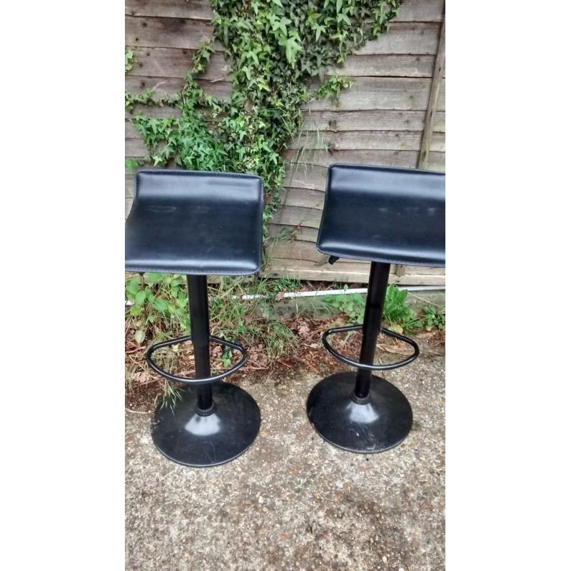 2 black leather padded gas strutted chairs/stools