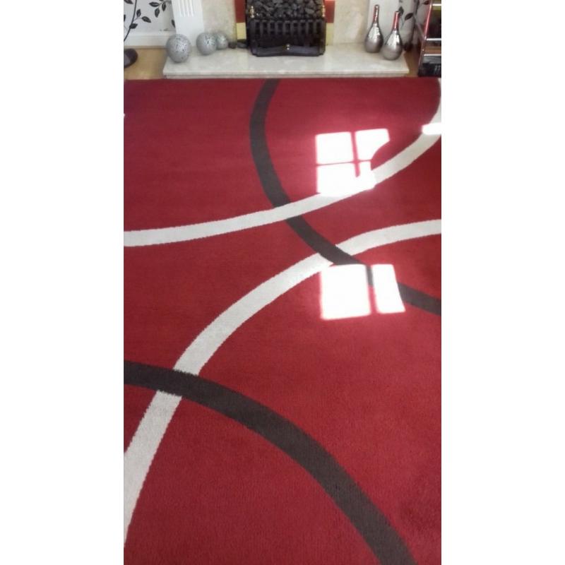 Large red rug. excellent cond.new colour scheme forces sale.230 x 180