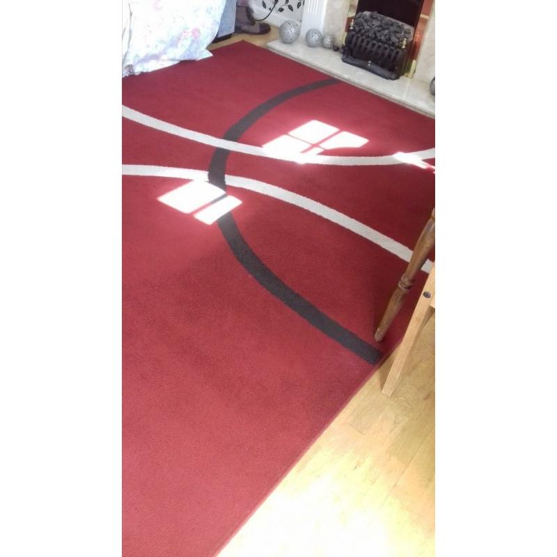 Large red rug. excellent cond.new colour scheme forces sale.230 x 180