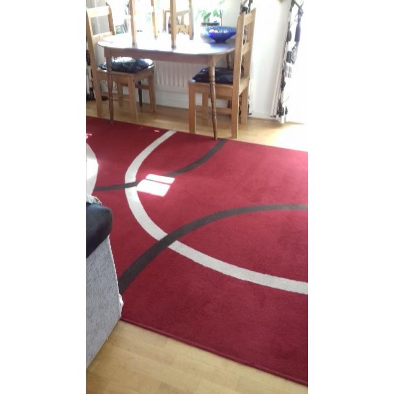 Large red rug. excellent cond.new colour scheme forces sale.230 x 180