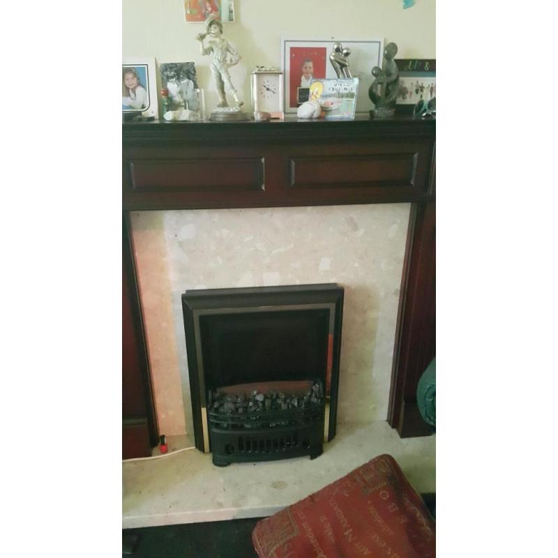 Dark wooden fire surround and electric coal effect fire