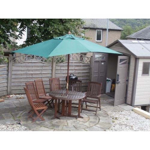 Substantial hardwood table,6 chairs and parasol