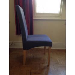 Extendable wooden dining room table in excellent condition with 4 grey material, wooden chairs.