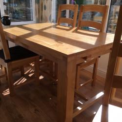 Beech table with drop leaf either end and six chairs
