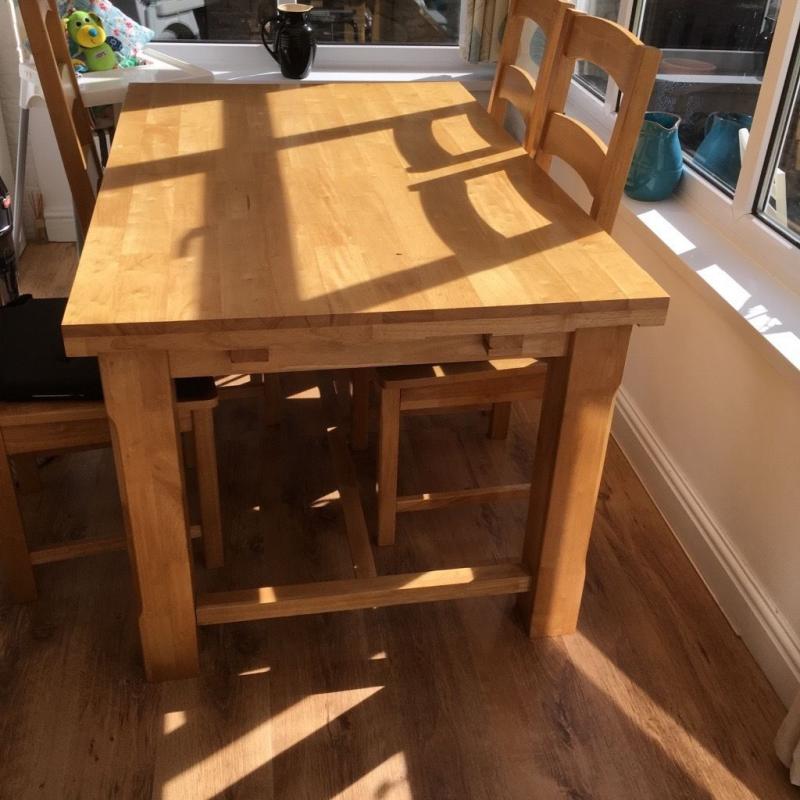 Beech table with drop leaf either end and six chairs