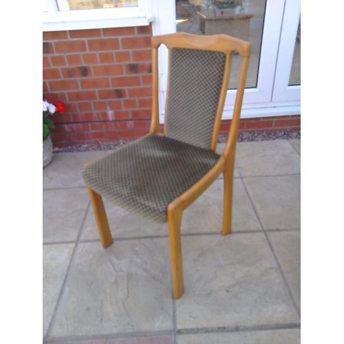 Light coloured solid wood round pedestal table and four upholstered chairs