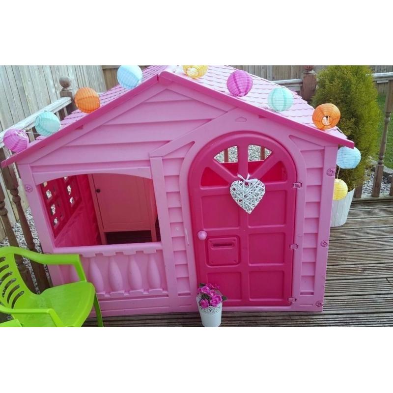 pink playhouse with table and chairs