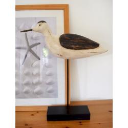 Large carved wooden bird on stand