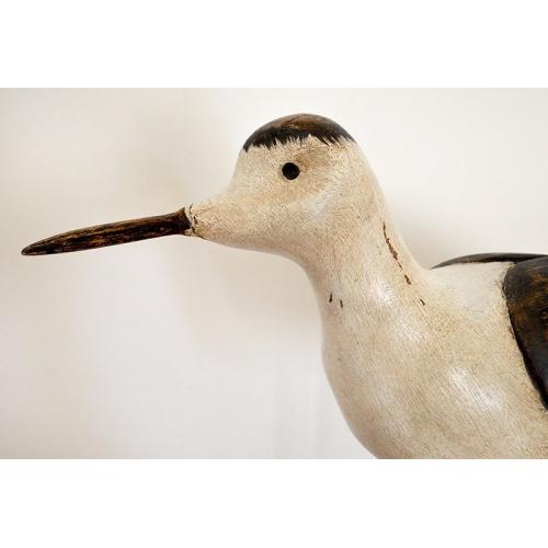 Large carved wooden bird on stand