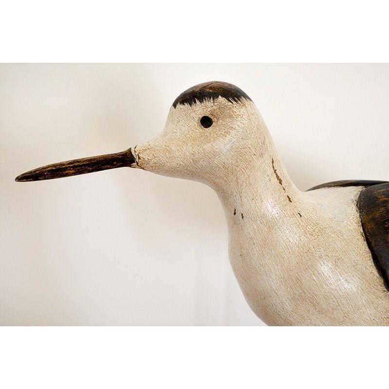 Large carved wooden bird on stand