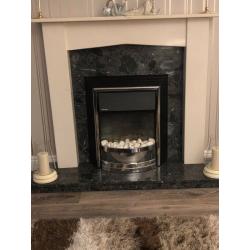 FIRE SURROUND ON BLACK MARBLE HEARTH AND BACK
