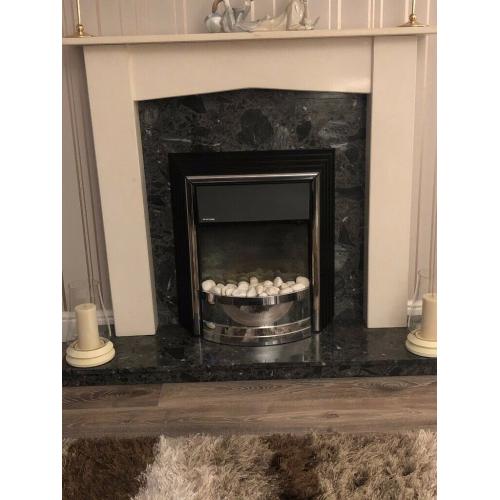 FIRE SURROUND ON BLACK MARBLE HEARTH AND BACK